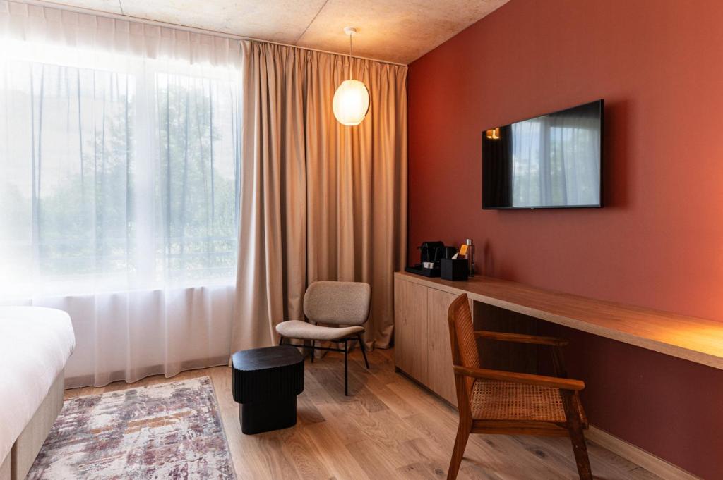TV a/nebo společenská místnost v ubytování voco Beaune , Cité des Vins by IHG