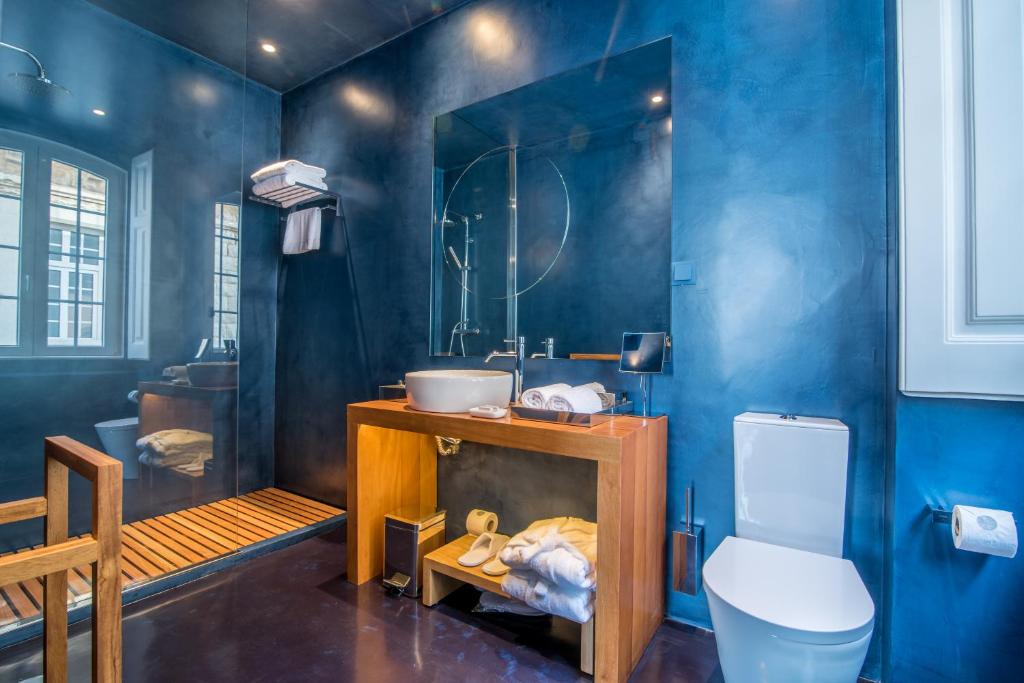 a blue bathroom with a sink and a toilet at Villa Cascais Boutique Hotel in Cascais