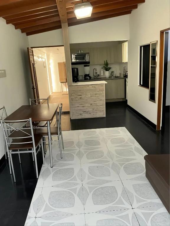 a kitchen and dining room with a table and chairs at Aparta Suites Torre de Prado 501 Apartamento para 7 Personas in Medellín