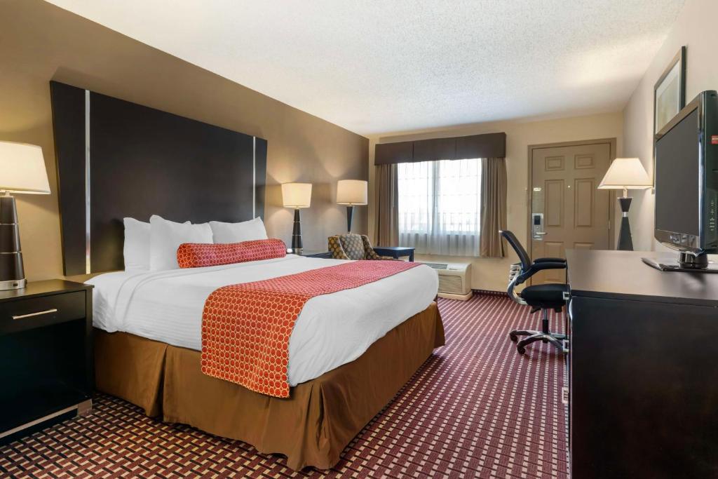 a hotel room with a bed and a television at Best Western Van Buren Inn in Van Buren