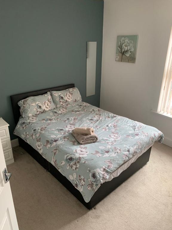 a bed in a bedroom with a blanket on it at Apple blossom cottage contractor and holiday accommodation in Cleethorpes