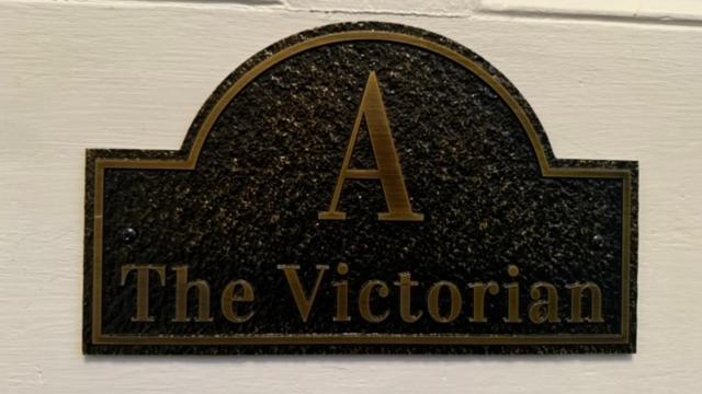 a sign on a wall with a letter a on it at The 1885 Suites in Picton