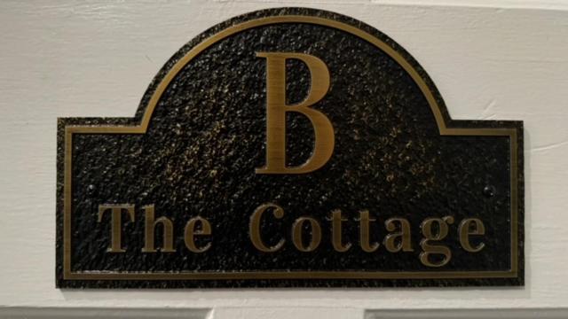 a sign for the coffee house with the letter b at The 1885 Suites in Picton