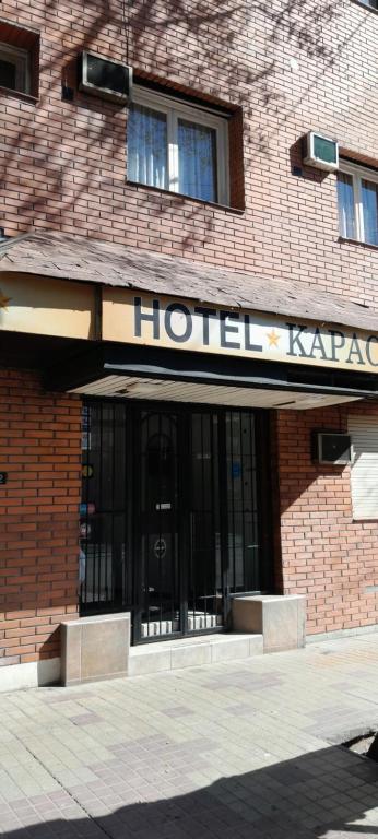 a hotel building with a sign on the front of it at Hotel Kapac in Mendoza