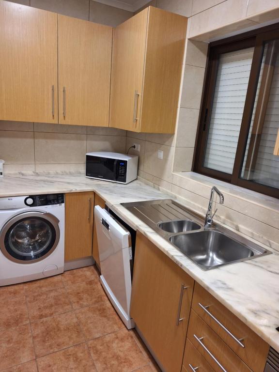 a kitchen with a sink and a washing machine at Monteverde in Monte Negro