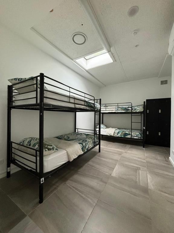 a room with two bunk beds and a ceiling at St Kilda Accommodation in Melbourne