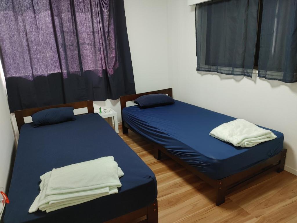 Postel nebo postele na pokoji v ubytování SamuraiBeach