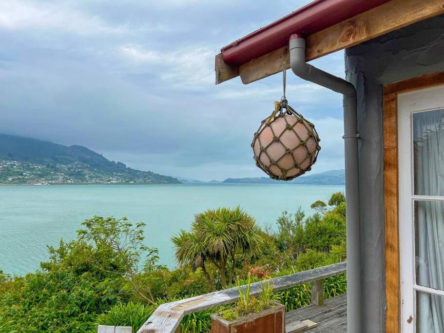 a view of the ocean from a house at Character Harbour Retreat in Dunedin