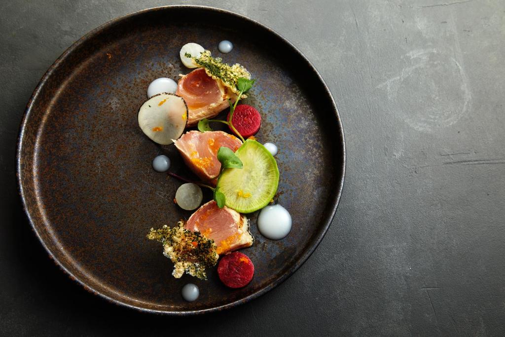 a plate of food with fruit and berries on a table at JW Marriott Hotel Nara in Nara