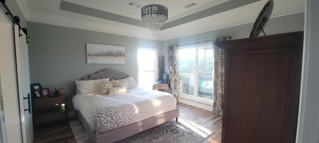 a bedroom with a bed and a window at Waterfront Bama Getaway-20 min to UA in Englewood