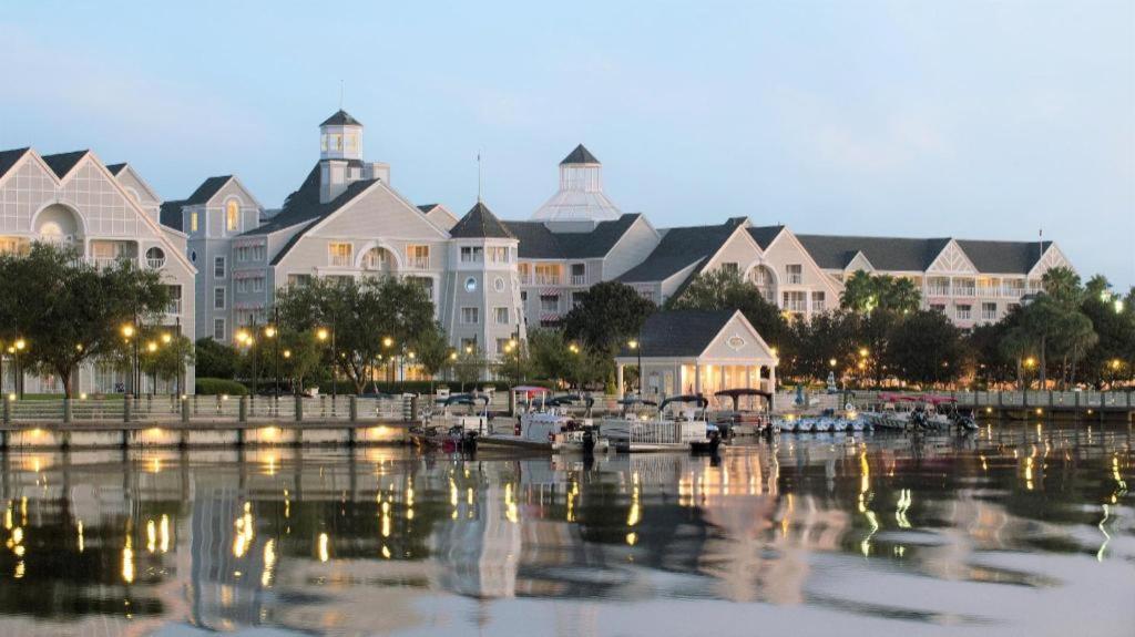 a marina with boats in front of a large building at Disney's Yacht Club Resort in Orlando