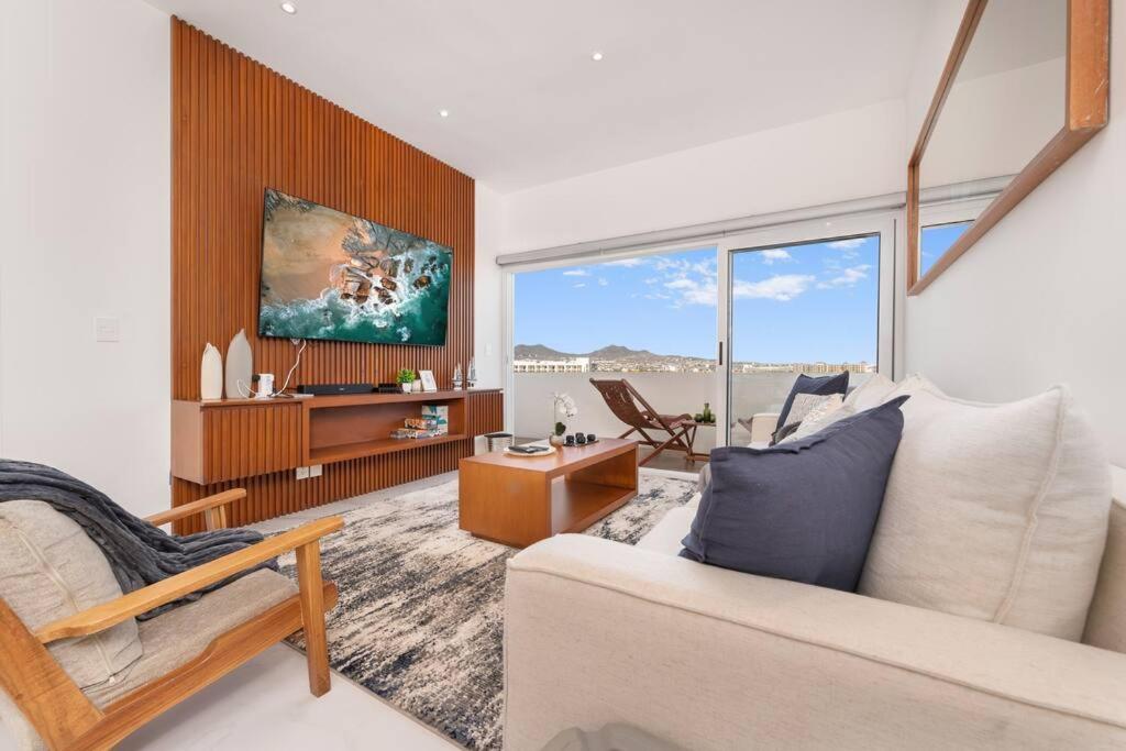 a living room with a couch and a table at NEW Condo at El Medano in Cabo San Lucas