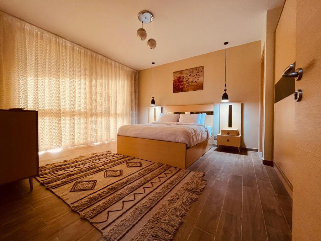 a bedroom with a bed and a large window at المونت جلاله - ll Monte Galala Ain Sokhna in Ain Sokhna