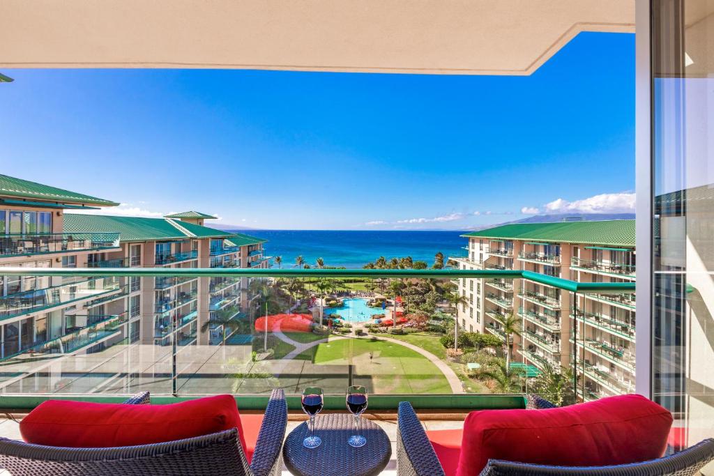 a balcony with chairs and a view of the ocean at Honua Kai Hokulani 825 in Lahaina