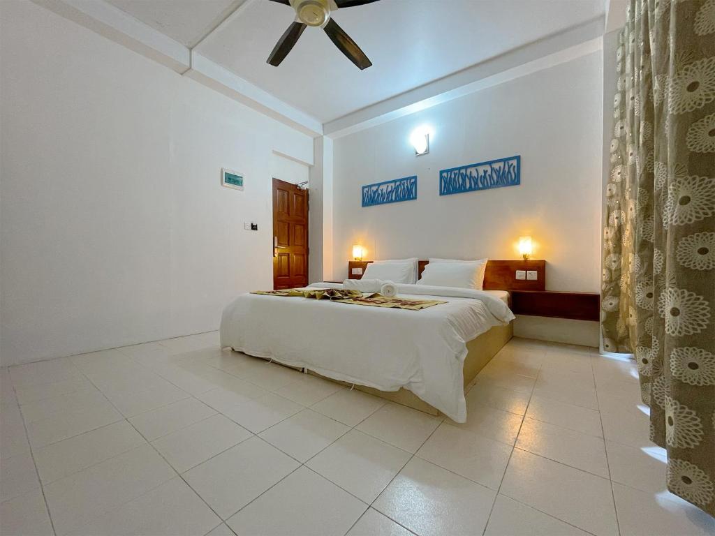 Postel nebo postele na pokoji v ubytování Paradise Retreat, Maafushi