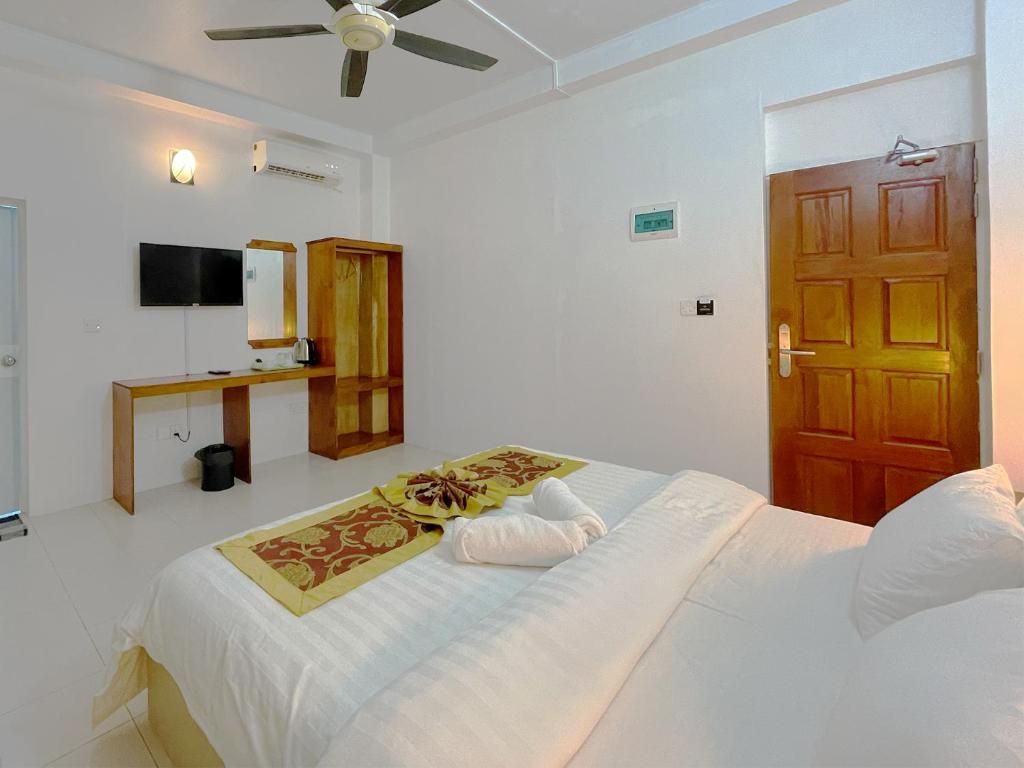 Postel nebo postele na pokoji v ubytování Paradise Retreat, Maafushi