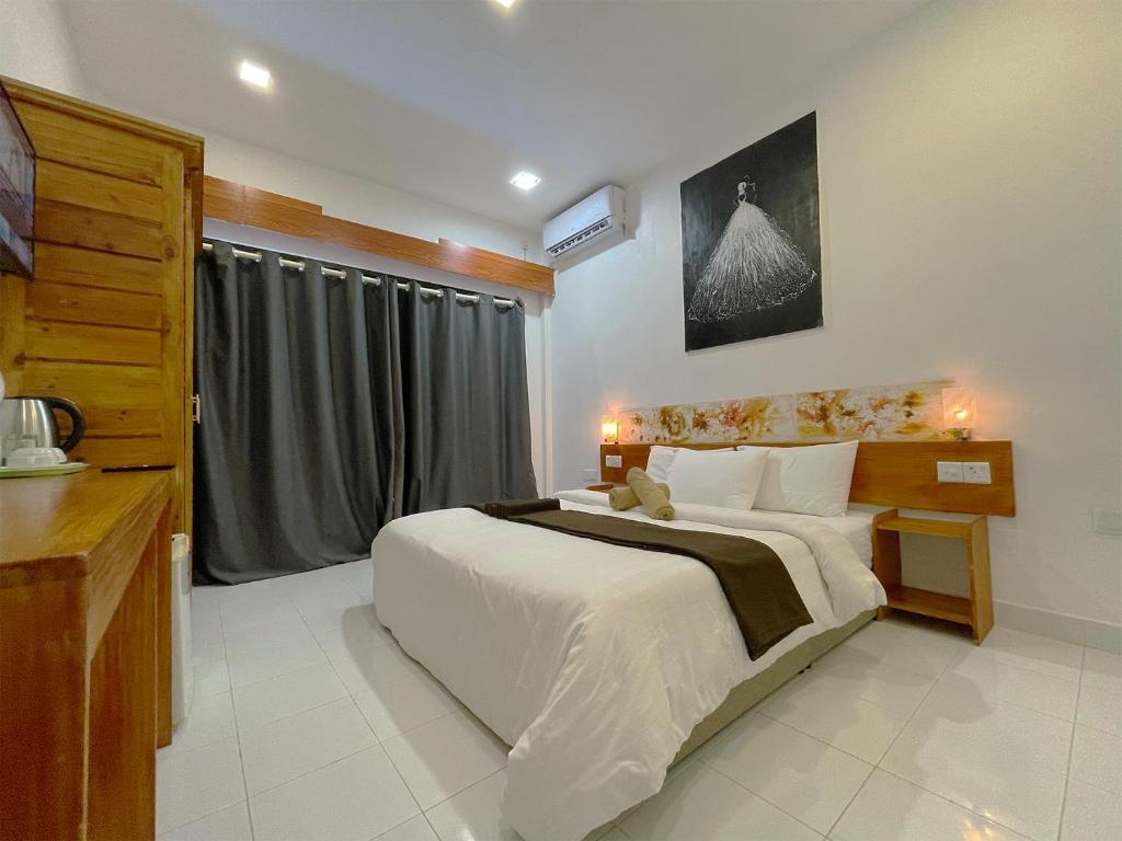 Postel nebo postele na pokoji v ubytování Paradise Retreat, Maafushi