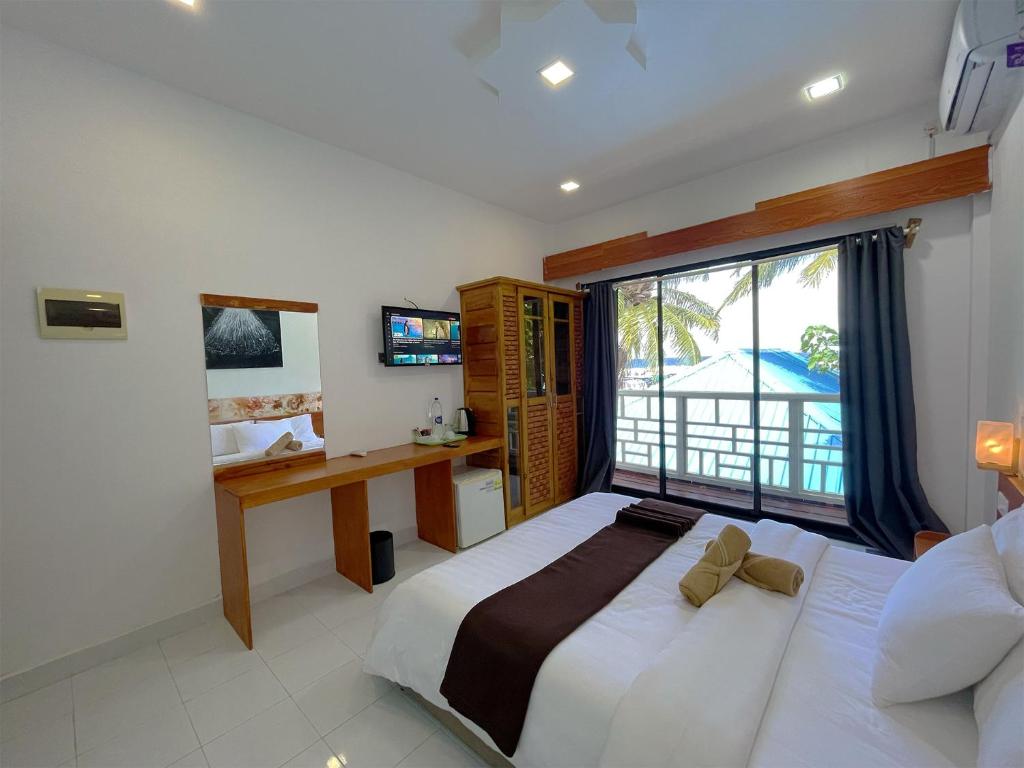 Postel nebo postele na pokoji v ubytování Paradise Retreat, Maafushi