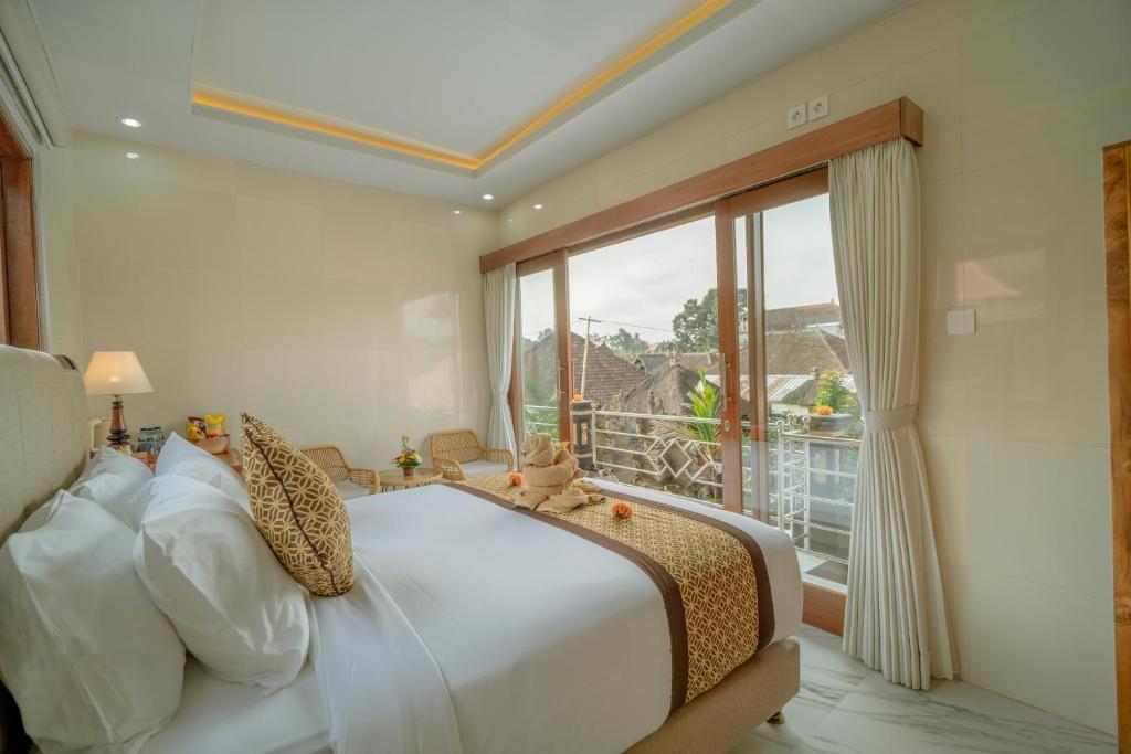Postel nebo postele na pokoji v ubytování Ashanti Guest House Ubud