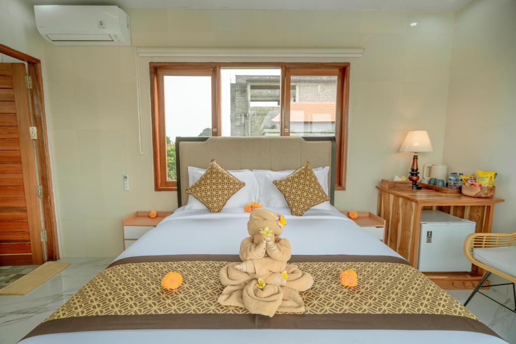 Postel nebo postele na pokoji v ubytování Ashanti Guest House Ubud