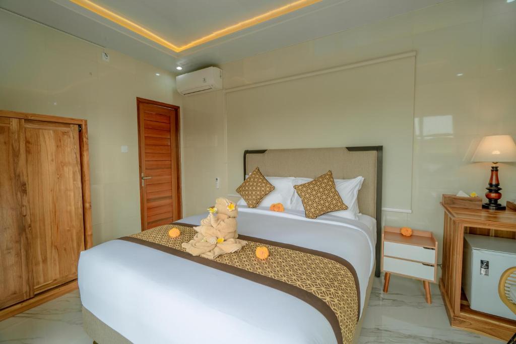 Postel nebo postele na pokoji v ubytování Ashanti Guest House Ubud