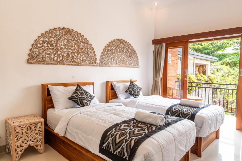 Postel nebo postele na pokoji v ubytování Ubud Ayu