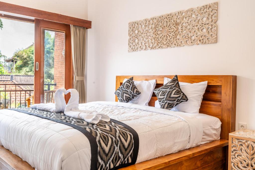 Postel nebo postele na pokoji v ubytování Ubud Ayu