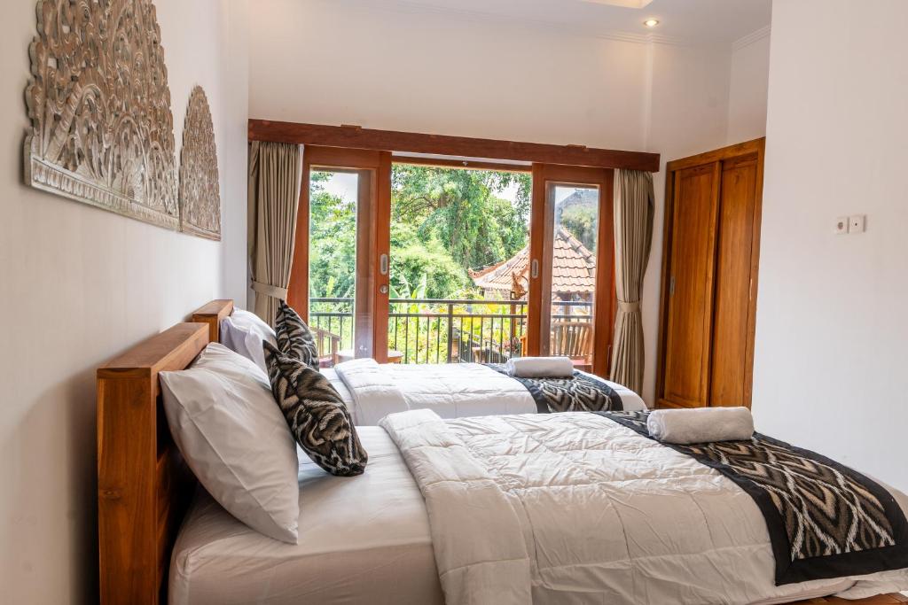 Postel nebo postele na pokoji v ubytování Ubud Ayu