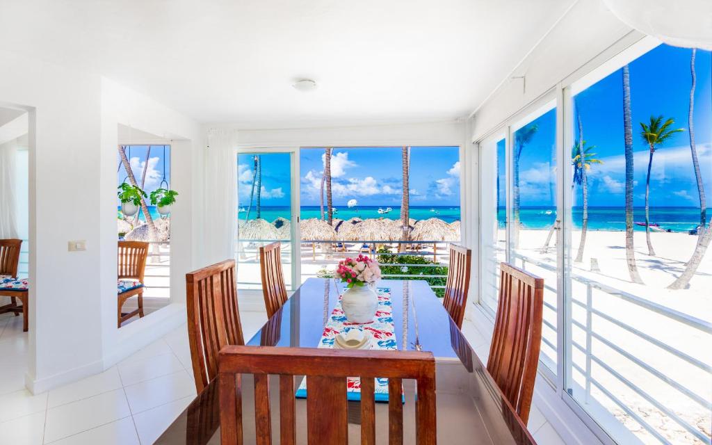 a dining room with a table and a view of the ocean at Prime Ocean View Punta Cana Apartments - 3-Bedroom Getaway with Private Terrace on Bávaro Beach in Punta Cana