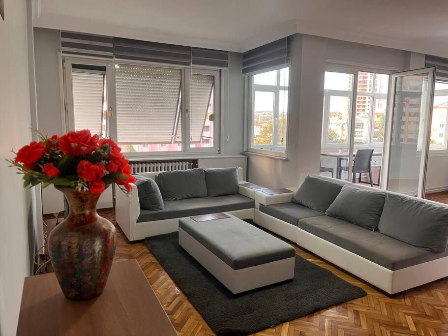 a living room with couches and a vase with flowers at Spacious flat with wide view in Istanbul