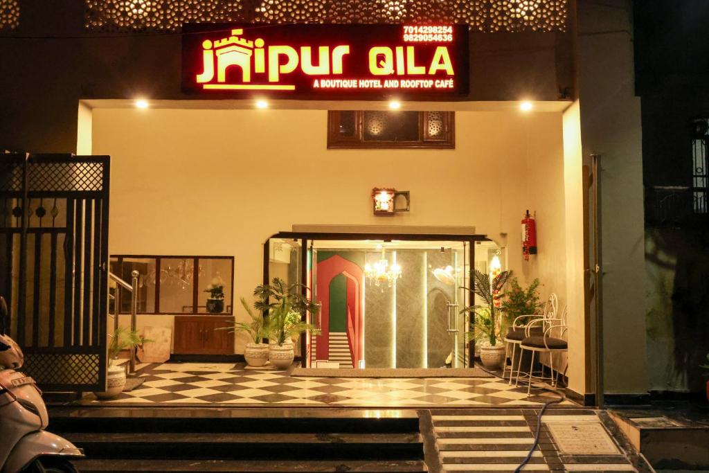 an entrance to a building with a sign on it at Jaipur Qila - A Boutique Hotel and Rooftop Cafe in Jaipur