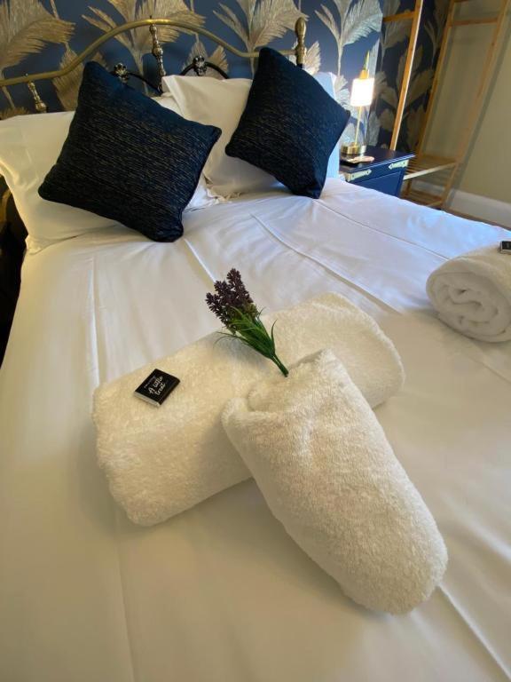 a white towel animal on top of a bed at Harbour Heights Whitby in Whitby