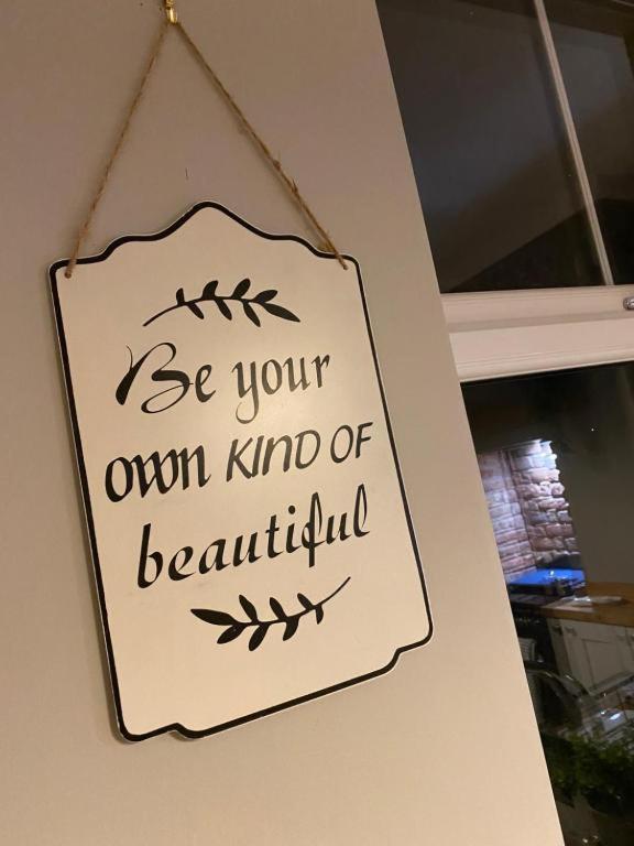 a sign on a wall that reads be your own kind of beautiful at Harbour Heights Whitby in Whitby