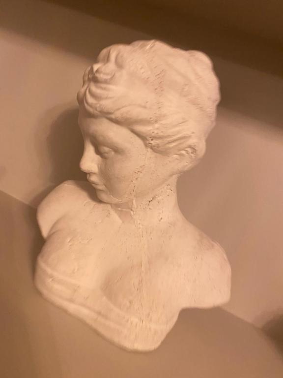 a bust of a woman hanging on a wall at Harbour Heights Whitby in Whitby