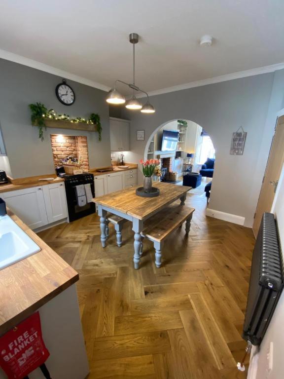 a kitchen with a wooden table in a room at Harbour Heights Whitby in Whitby