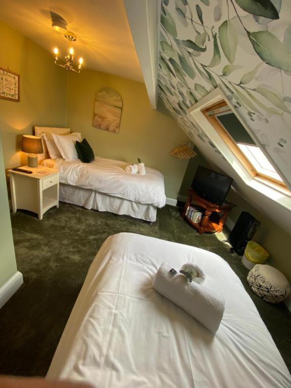 a hotel room with two beds and a window at Harbour Heights Whitby in Whitby