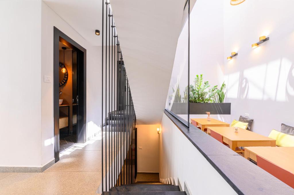a staircase in a building with tables and benches at Rokah Luxury Villa at Ramat HaHayal in Tel Aviv