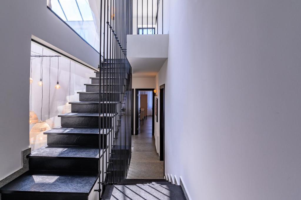 a staircase in a house with black railing at Rokah Luxury Villa at Ramat HaHayal in Tel Aviv