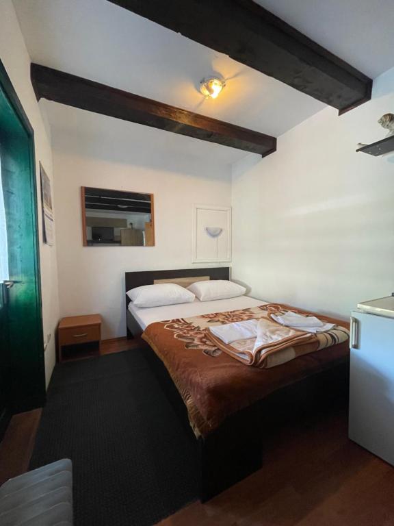 a bedroom with a large bed in a room at Dedina kuća 1937 in Mokra Gora