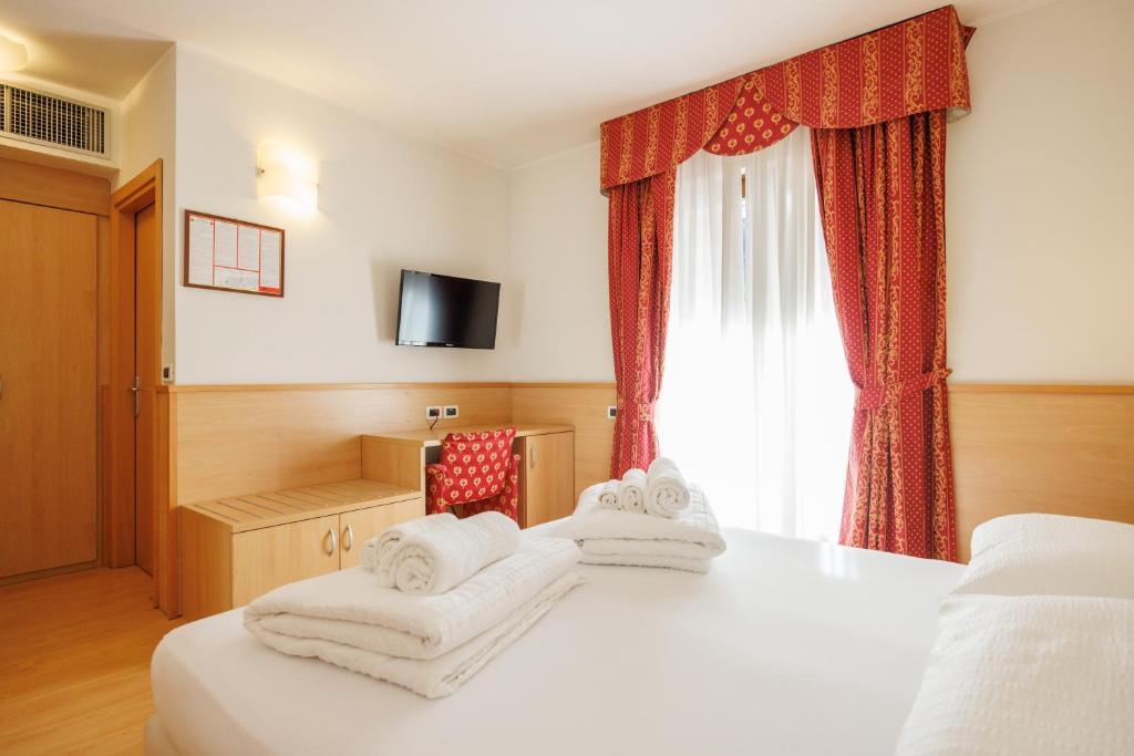 Postel nebo postele na pokoji v ubytování Club Hotel e Residence La Vela