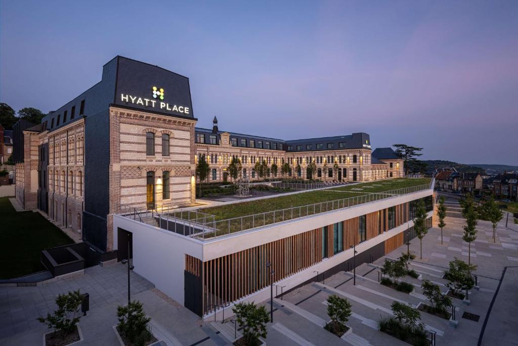 a large building with a sign on top of it at Hyatt Place Rouen in Rouen