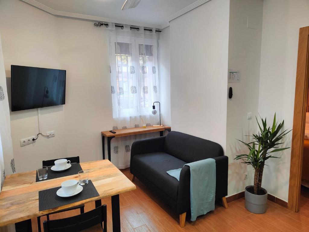 a living room with a couch and a table at VuT La Casita del Cuéntame in Burgos