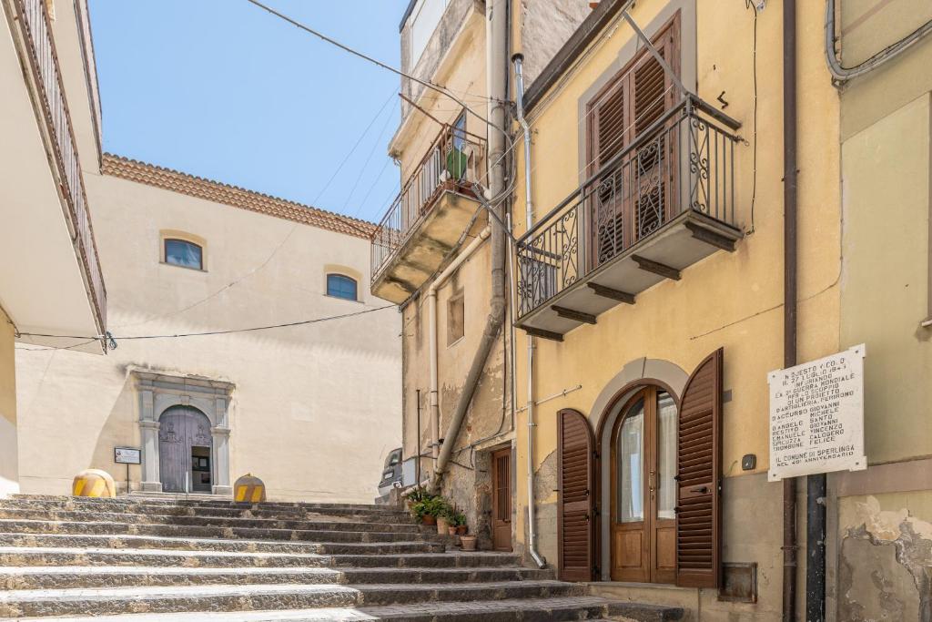 a group of buildings with stairs in a street at La Casa del Sarto in Sperlinga