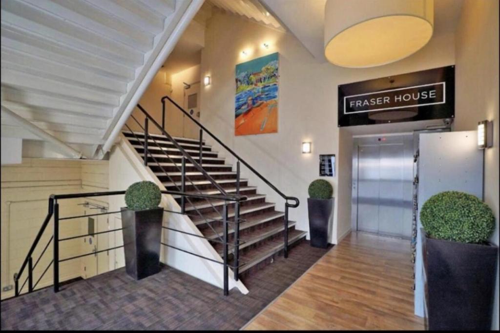a lobby with stairs and a larger house sign at Lovely Twin 2-Flats Condo In Aberdeen-No Party in Aberdeen