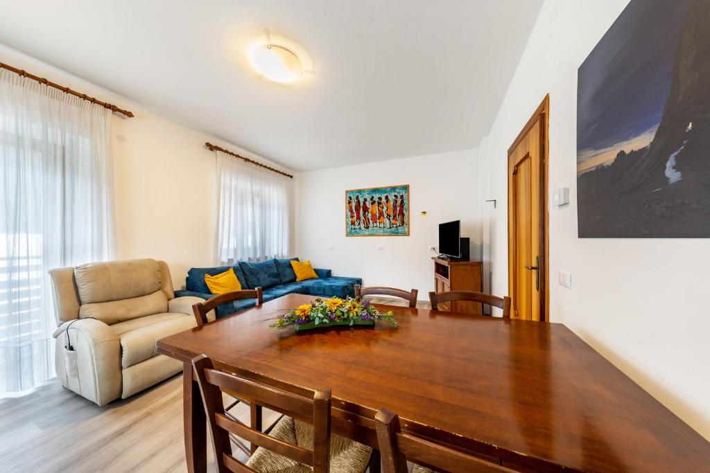 a living room with a table and a couch at Casa Da Rin Giulia in Auronzo di Cadore