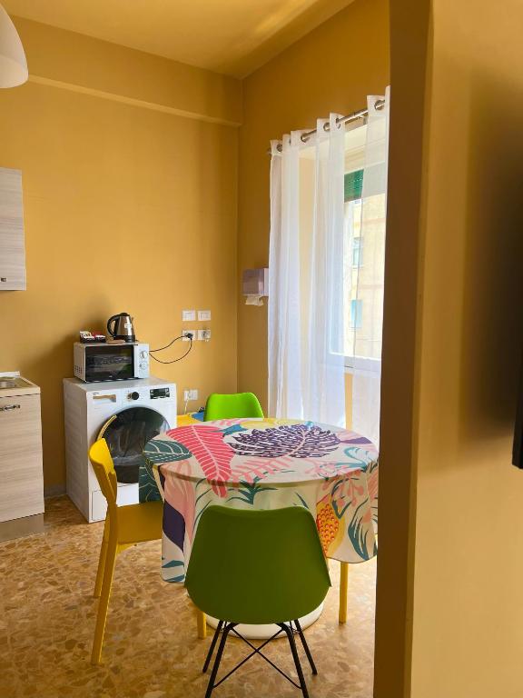 a kitchen with a table and chairs and a window at Apartment Sonnino 37 in Cagliari