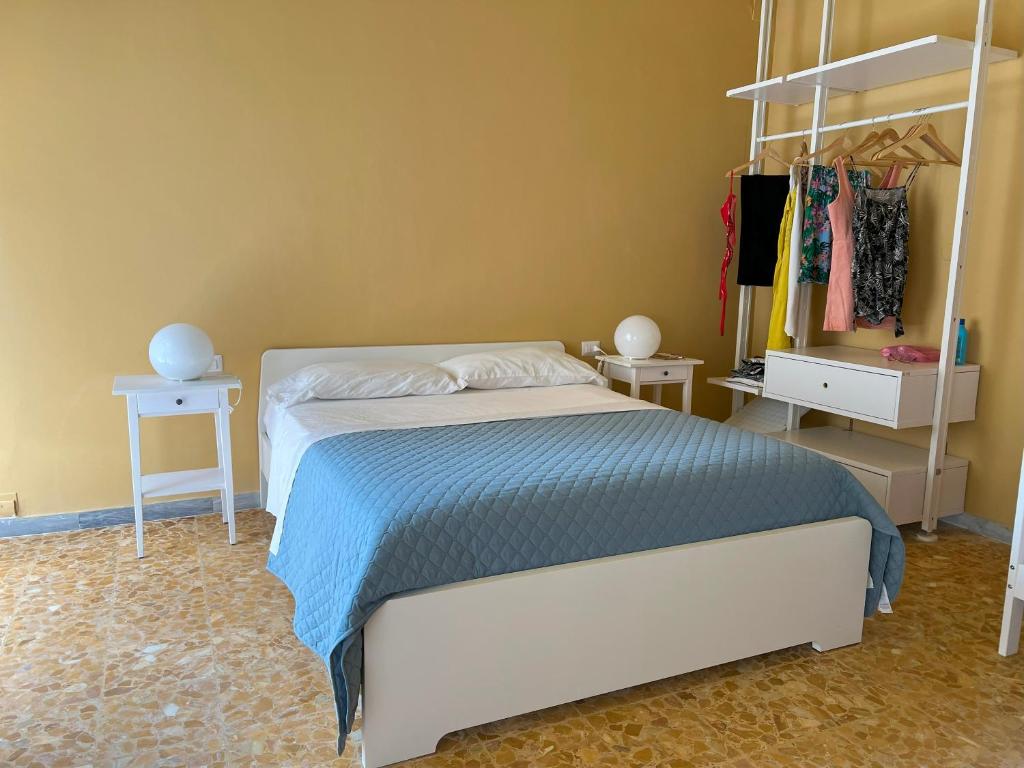 a bedroom with a bed and a rack of clothes at Apartment Sonnino 37 in Cagliari