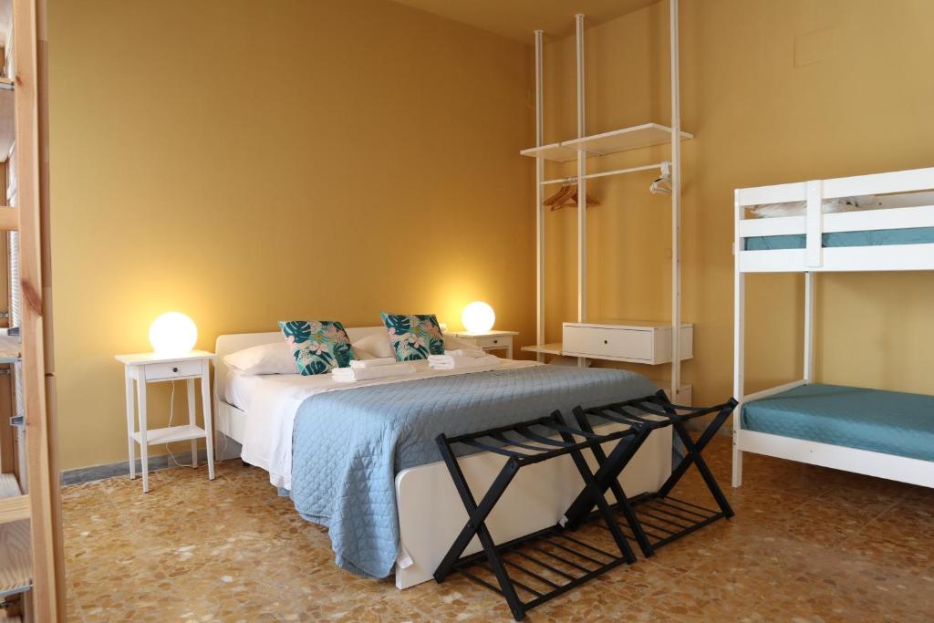 a bedroom with a bed and two bunk beds at Apartment Sonnino 37 in Cagliari