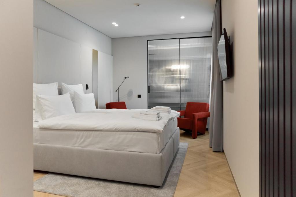 Postel nebo postele na pokoji v ubytování Hotel Laudon