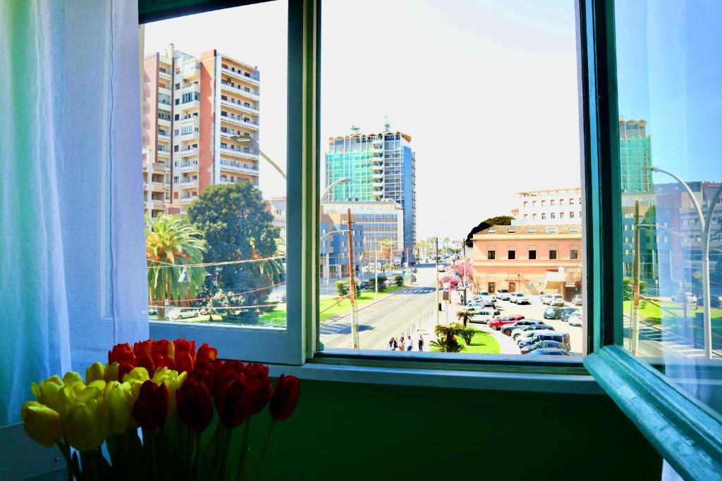 a window with red and yellow tulips in a window sill at Apartment Sonnino 37 in Cagliari